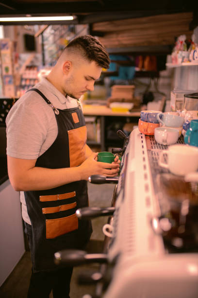 Attentive male person looking at cup of milk