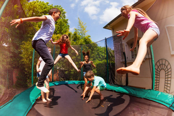 istock Happy friends jumping on the trampoline in summer 1058002320