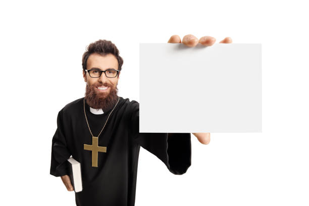 istock Young priest holding a blank card 1058004330