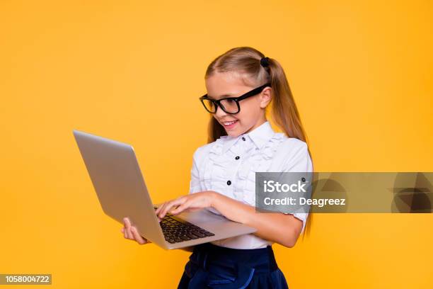 Estudying Concept Side Profile Close Up Photo Portrait Of Cute Lovely Intelligent Nice Schoolkid Watching Video Skype Holding Netbook Ind Hand Doing Homework Isolated Background Stock Photo - Download Image Now