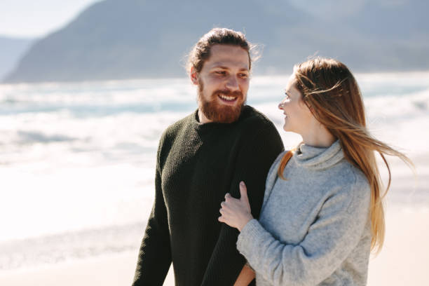 istock Handsome man walking with his girlfriend at the beach 1058006750