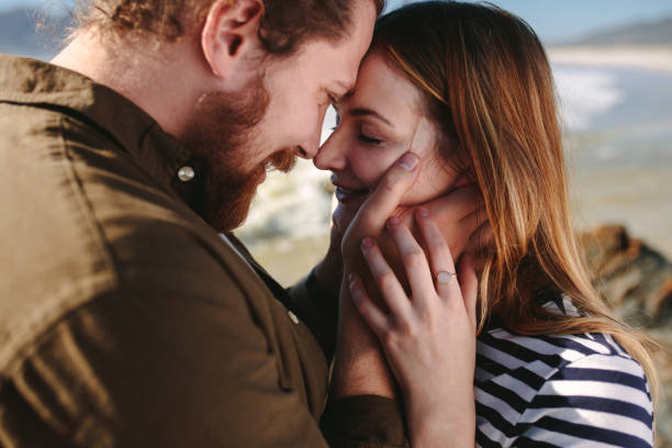 istock Couple in love on the beach 1058006782