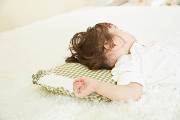 istock Adorable little child girl sleeping in the bed. 1058007782