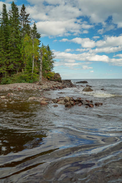 istock Clouds, Woods and Lake Superior Waves in Minnesota 1058010132
