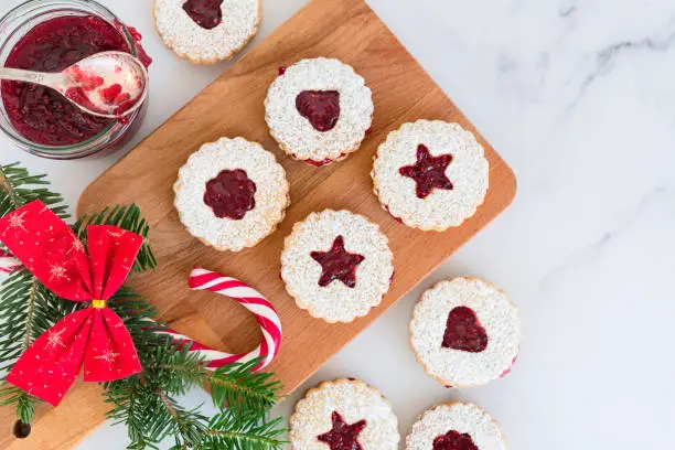 Linzer Christmas cookies with jam and powder sugar flat lay and copy space. Creative concept.