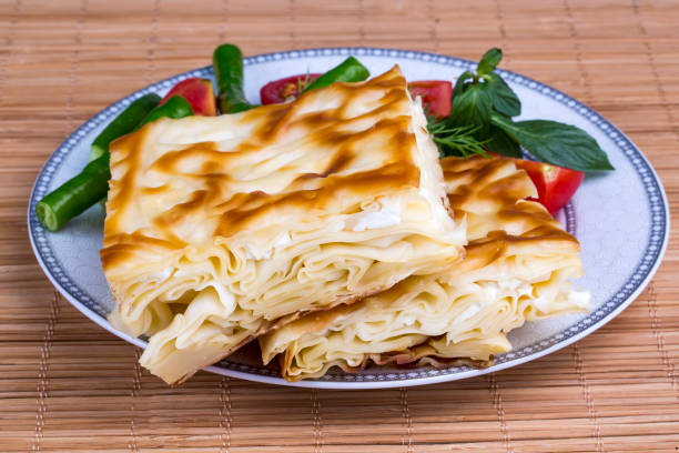 istock Turkish style meat and cheese stuffed filo dough borek served su boregi 1058014470