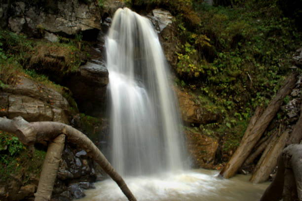 istock Waterfall in the autumn forest. Autumn landscape 1058016678