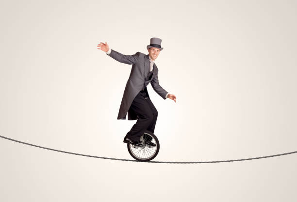 Extreme business man riding unicycle on a rope