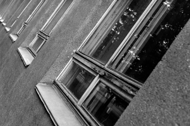 istock Row of old windows. Endless path concept. Windows of building need to be repaired or replaced. 1058017664