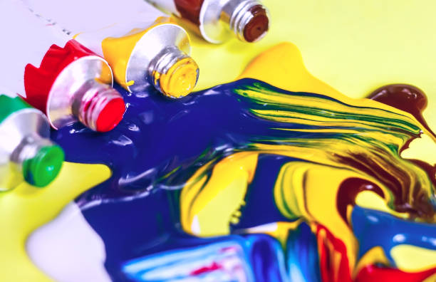 istock acrylic paint and artistic brush squeezed out against a yellow background, close-up, selective focus 1058020114
