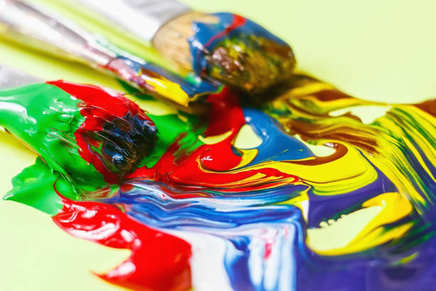 istock acrylic paint and artistic brush squeezed out against a yellow background, close-up, selective focus 1058020116