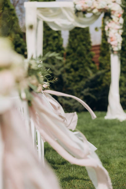 istock wedding decor ceremony arch chairs flowers ribbons 1058020378