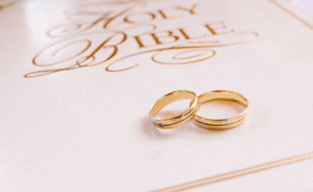 istock gold rings wedding bible white book religion 1058020470