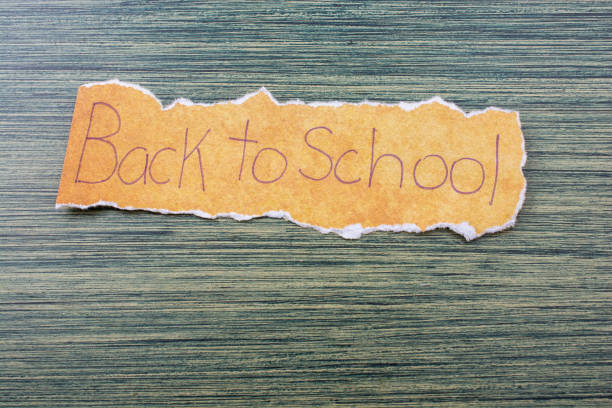 istock Back to school wording on  torn paper 1058021760