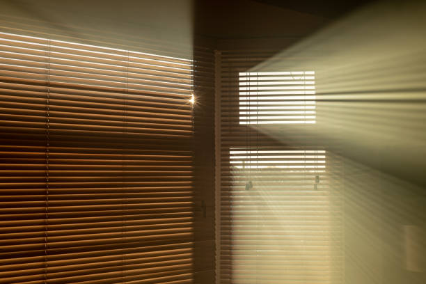 istock Sun streaming through window blinds into a smoky room 1058024306