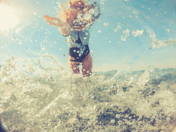 istock Playful Young Woman in the Split Sea, half under water half above 1058025178