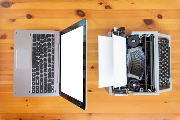 istock Old typewriter vs new laptop on the table. Concept of technology progress. 1058025430