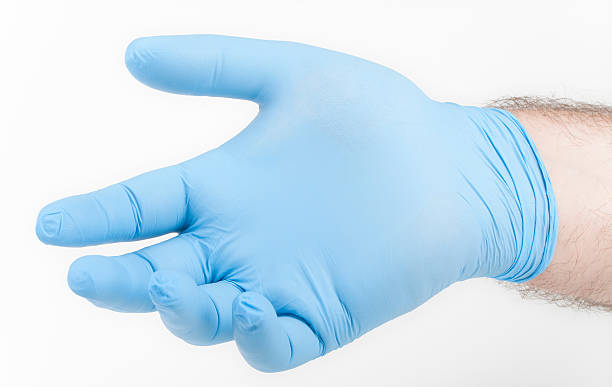 istock Man's hand wearing blue glove 105802604