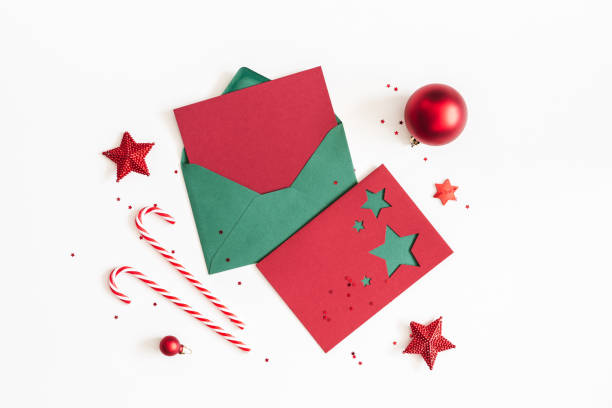 istock Christmas composition. Envelope, paper card, red decorations on white background. Christmas, winter, new year concept. Flat lay, top view, copy space 1058026086