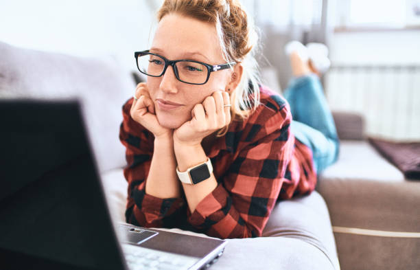 istock Pretty woman with laptop working at home 1058026166