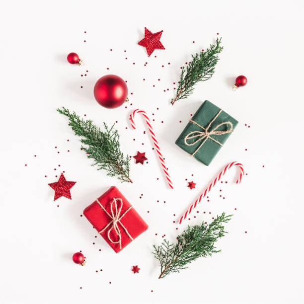 istock Christmas composition. Gifts, fir tree branches, red decorations on white background. Christmas, winter, new year concept. Flat lay, top view, copy space, square 1058027726