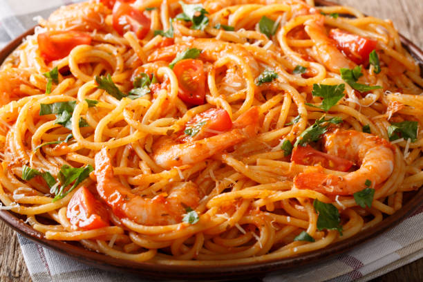 istock Spicy spaghetti with shrimps in tomato sauce close-up. horizontal 1058027884