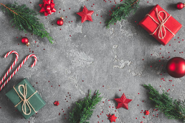 istock Christmas composition. Gifts, fir tree branches, red decorations on black background. Christmas, winter, new year concept. Flat lay, top view, copy space 1058028042