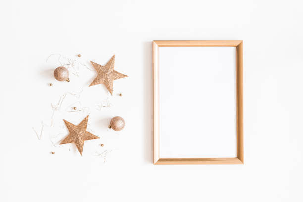 istock Christmas composition. Photo frame, golden decorations on white background. Christmas, winter, new year concept. Flat lay, top view, copy space 1058028576