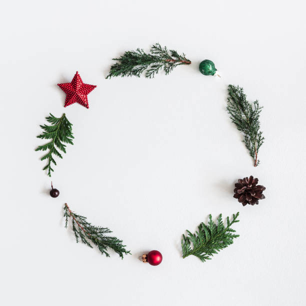 istock Christmas composition. Wreath made of coniferous tree branches, balls, pine cones on pastel gray background. Christmas, winter, new year concept. Flat lay, top view, square, copy space 1058028854