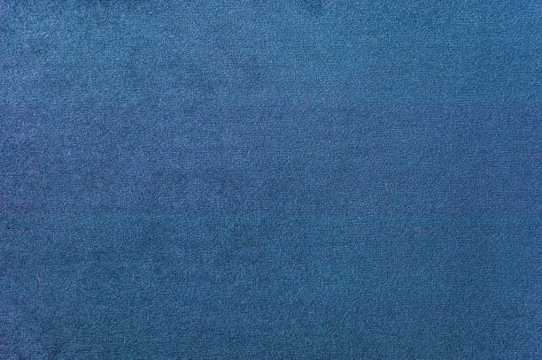 Texture of a dark blue carpet. Close-up of gradient light stock photo
