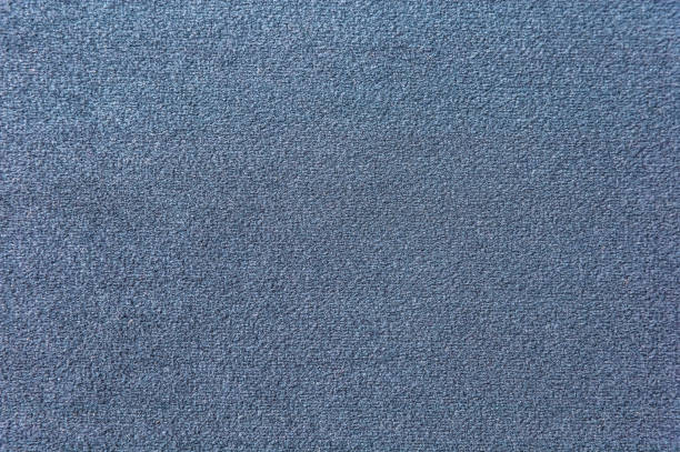 濃いブルーのカーペットの質感。グラデーション ライトのクローズ アップ - carpet sample ストックフォトと画像