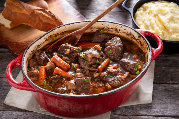 Beef Bourguignon Beef Bourguignon in an Enameled Cast Iron Dutch Oven cooked selective focus indoors studio shot stock pictures, royalty-free photos & images