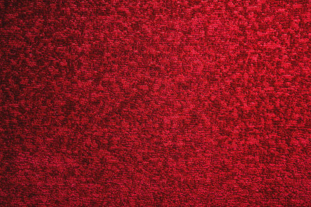 istock Texture of a dark red carpet. Close-up of gradient light 1058029384