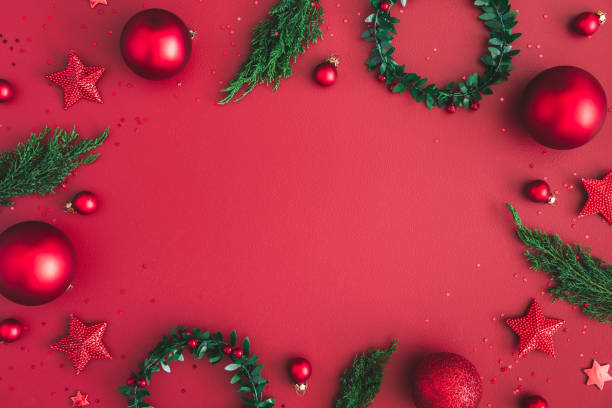 istock Christmas composition. Christmas red decorations, fir tree branches on red background. Flat lay, top view, copy space 1058031960
