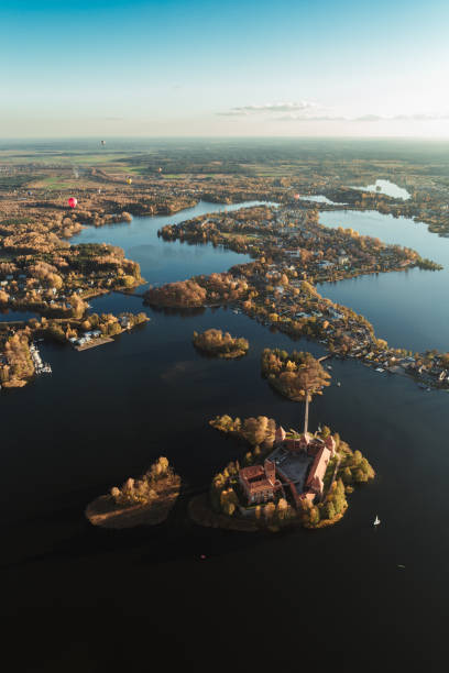 istock Flying over castle lake hot air balloon 1058035566