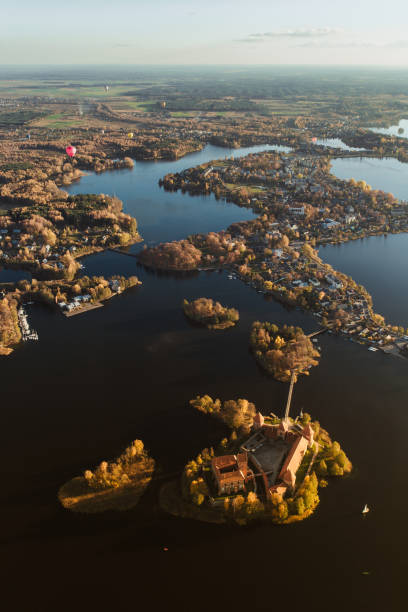 istock Flying over castle lake hot air balloon 1058035572