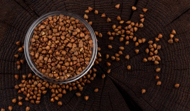 istock Bowl of buckwheat grains on black background. Top view 1058036132