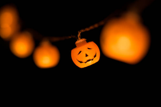 istock Halloween pumpkin garland glowing in the dark 1058041274