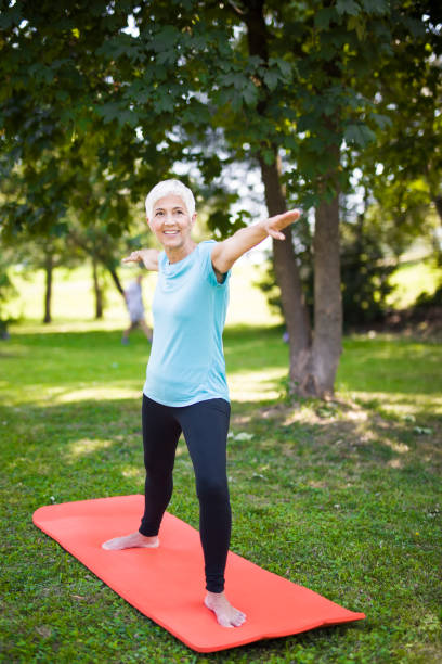 istock Senior woman doing exercise in the green park 1058041970