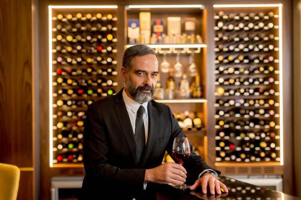 istock Handsome mature man tasting red wine 1058042200