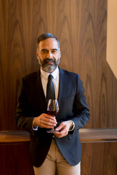 istock Handsome man with glass of red wine 1058042242