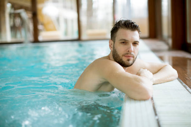 istock Handsome young man relaxing in hot tub 1058042472