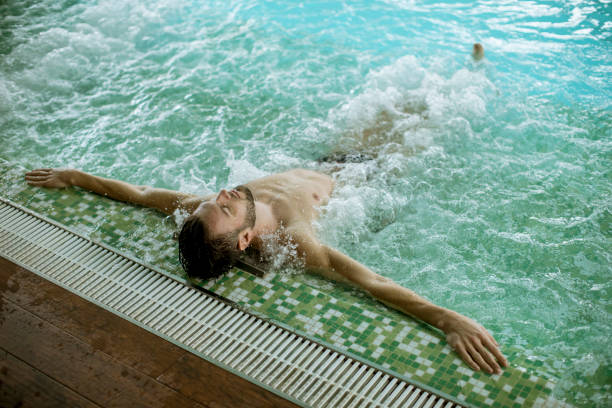 istock Handsome young man relaxing in hot tub 1058042484