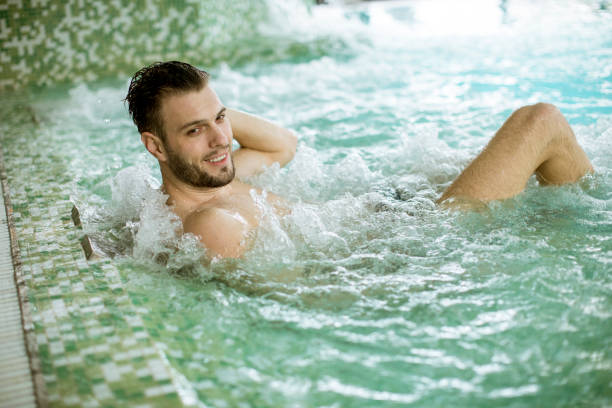 istock Handsome young man relaxing in hot tub 1058042486