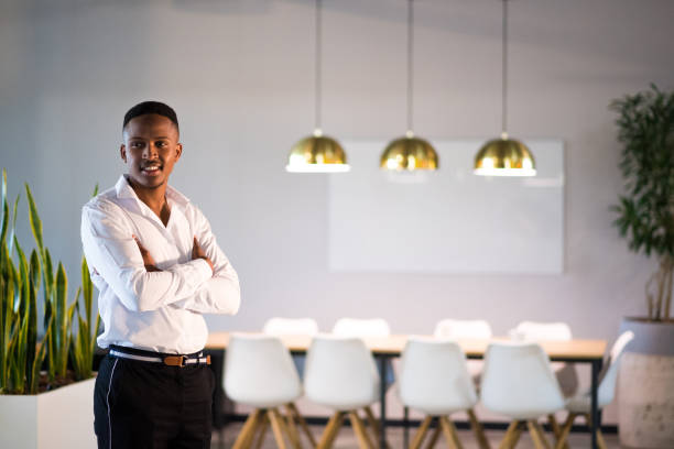 istock Successful millennial entrepreneur stands proudly in his office 1058043658