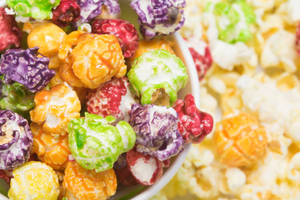 istock popcorn in colored caramel glaze, close-up background 1058043818