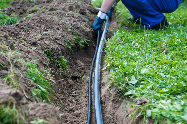 istock a worker lays a water pipe into the ground 1058043846