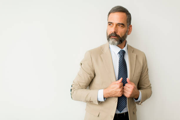 istock Bearded businessman by wall 1058044086