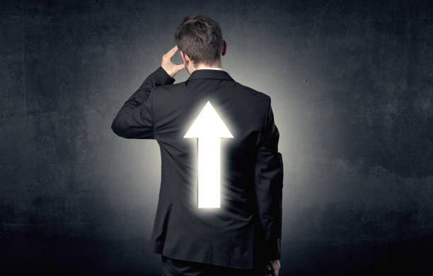 istock Young businessman standing with arrow on his back 1058045132