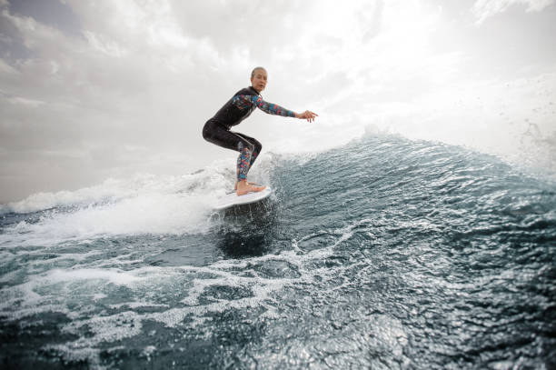 istock Active woman riding on the white wakeboard 1058045158